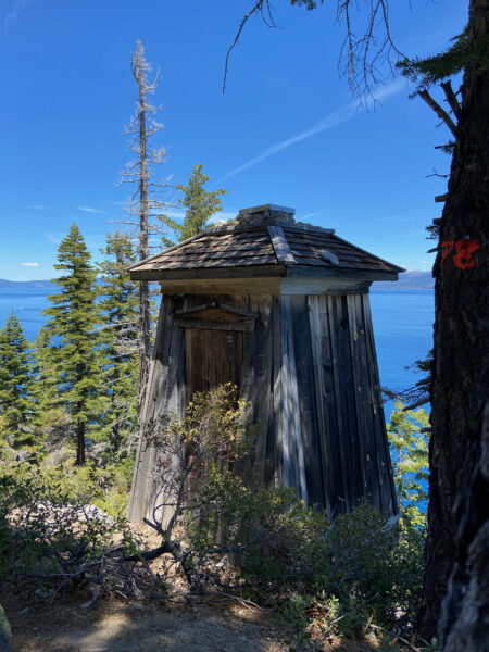 old wooden lighthouse building along hiking trail