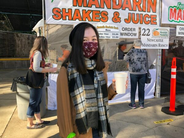 girl in mask holding milkshake