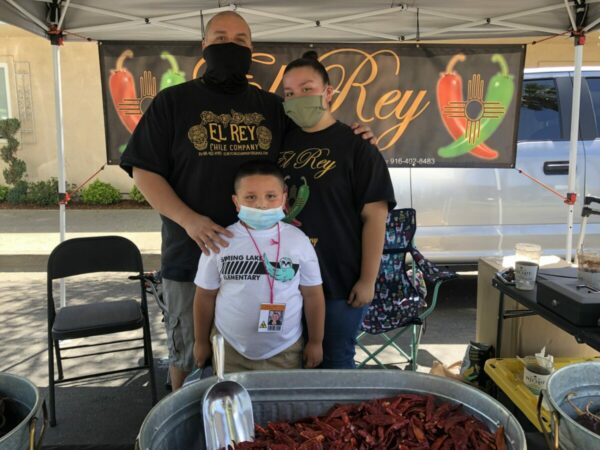 Family at their chili pepper stand at farmers market