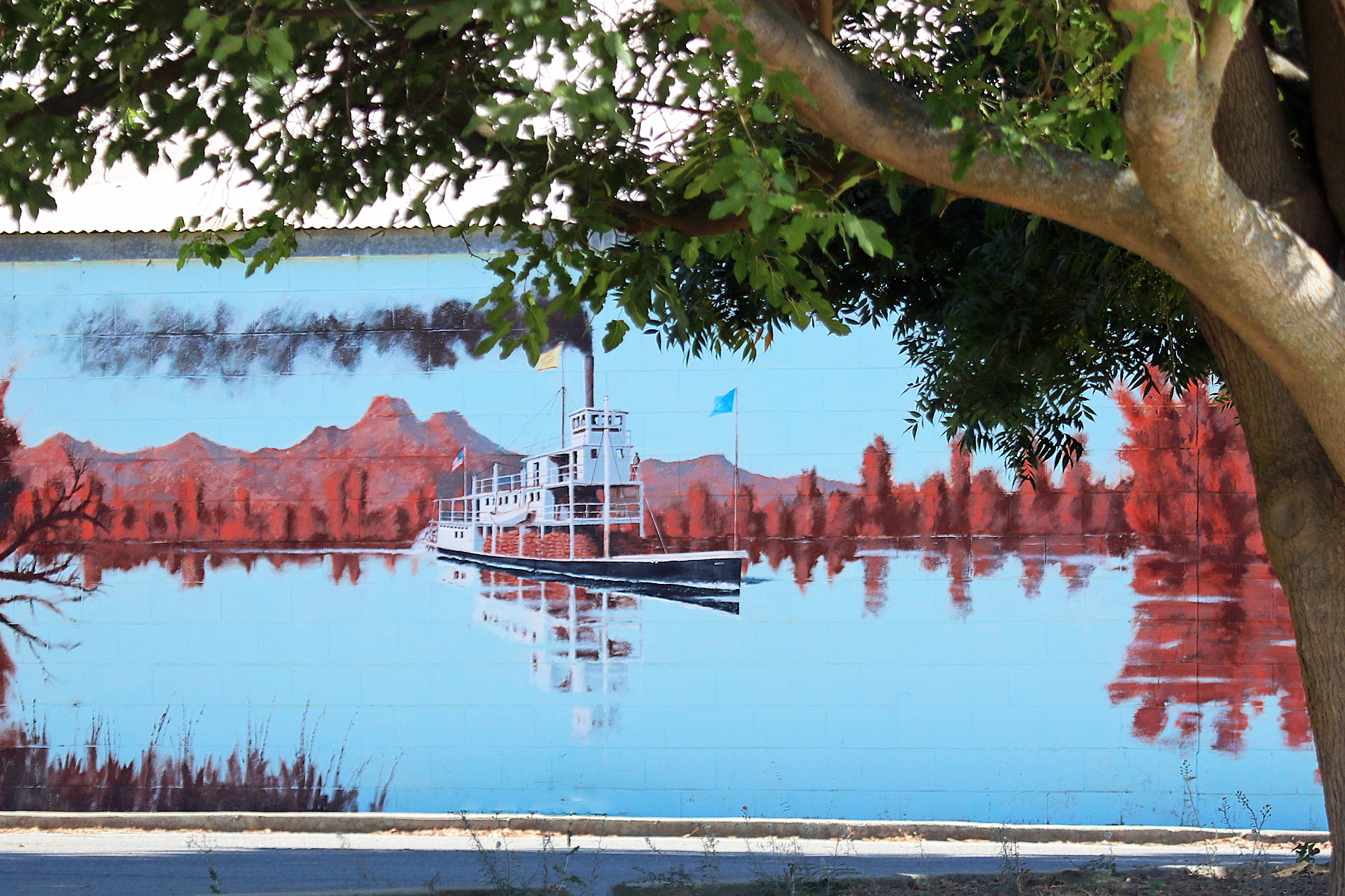 mural of a boat on the river