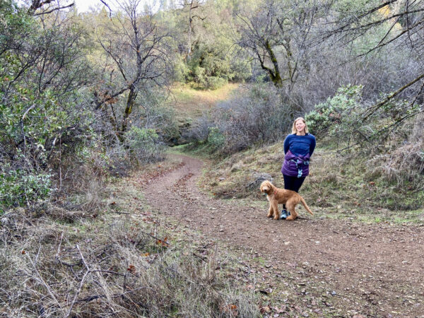 woman and dog on hiking trail