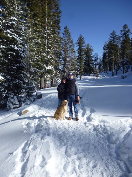 Couple with dog in the snow