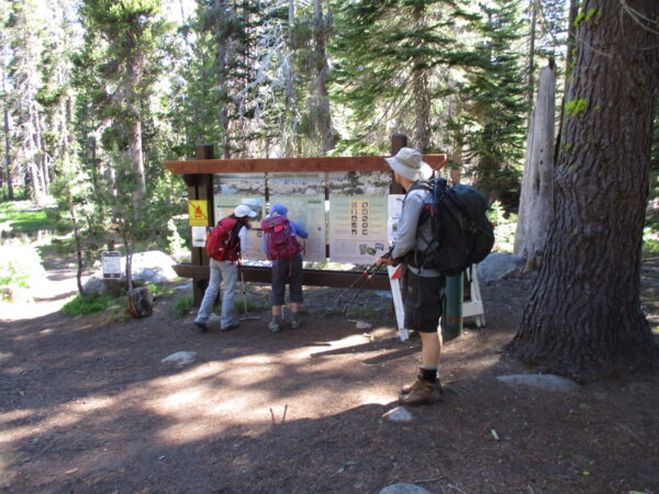 hikers inspecting a trail map